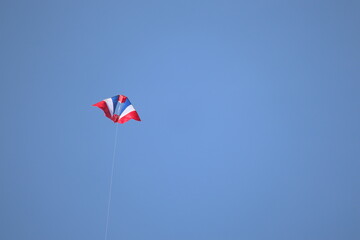 Thai flag pattern kite flying in the blue sky on children's holiday