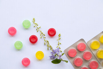 colorful sough sore pastille pills from herbal arrangement flat lay style on background white