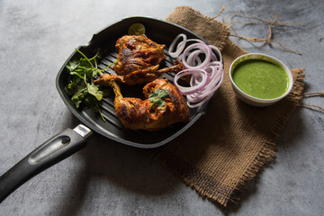 Close up of  popular Indian snacks chicken tandoori in a pan with use of selective focus
