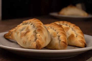 Traditional Argentinean empanadas pie on table, meat Chicken and vegetables