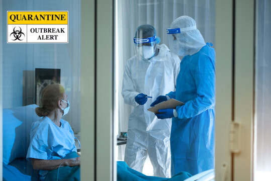Blurred image  of coronavirus covid 19 treatment background , patient on bed with doctors in PPE coverall suit in hospital negative pressure quarantine room, Quarantine Outbreak Alert sign .