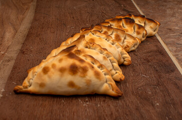 Traditional Argentinean empanadas pie on table, meat Chicken and vegetables