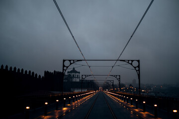 Fototapeta na wymiar View of the Dom Luis I Bridge and railway tracks at night, Porto, Portugal.
