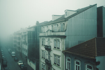 View of the buildings on foggy street in Porto, Portugal.