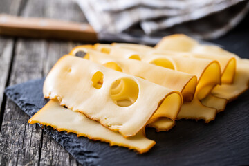 Sliced smoked hard cheese.