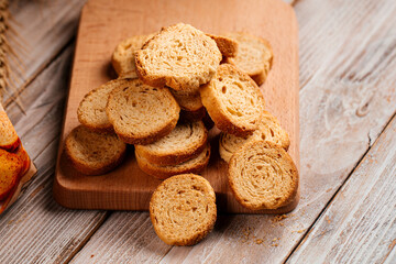 Closeup on pile of dried bread crackers on the wooden background