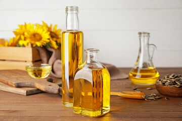 Bottles of sunflower oil on wooden background