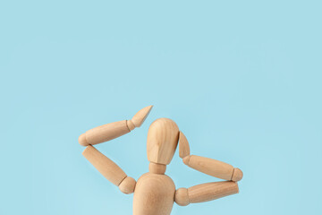 Wooden mannequin on color background