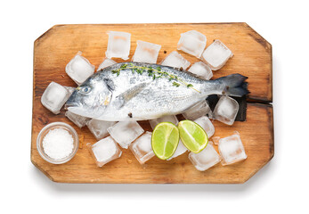 Board with raw dorado fish and lime on white background