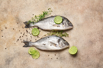Raw dorado fish with lime and spices on grunge background