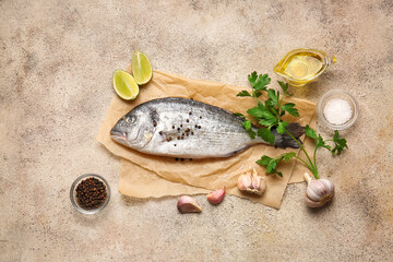 Raw dorado fish with ingredients on grunge background