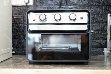 Air Fryer oven in the kitchen. Black Modern Electric Deep. Domestic Household & Small Kitchen Appliances.