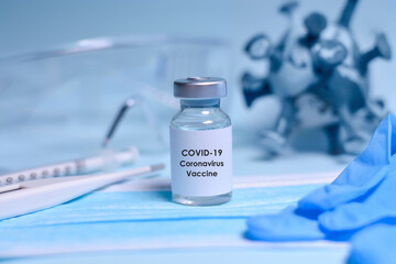 Medical bottle, Coronavirus vaccine, syringe , face mask, gloves, body thermometer, 3D model of virus and protective glasses. The concept of medicine, healthcare and science.