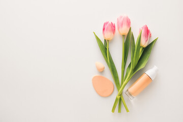 Cosmetics and flowers on white background