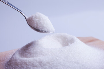 Salt or sugar on a teaspoon