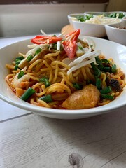 Closeup image of Malaysia famous spicy curry flavoured  noodles with shrimp and cockles.