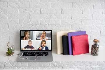 laptop with videoconference children classmates stands on the table