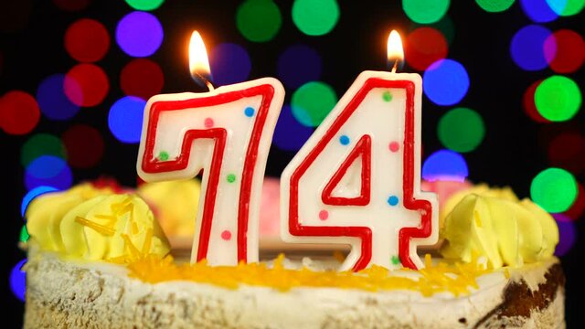 Number 74 Happy Birthday Cake With Burning Candles Topper.