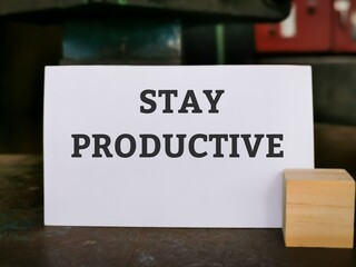 Selective focus with noise effect phrase STAY PRODUCTIVE written on white card. Business concept.