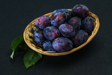 Ripe plum heap in the basket