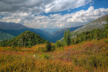 Mountain landscape. Mountain valley with mountains and clouds in the sky.