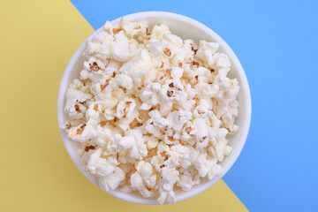 Popcorn in bowl on a red background. Close up. Top view