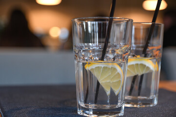 Water with lemon, drink, cocktail on the table in cafe with beautiful blurred background