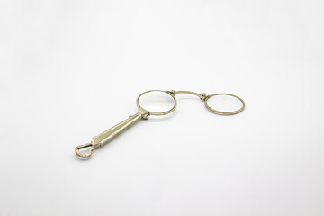 Old vintage lorgnette from the middle of the nineteenth century on the white background