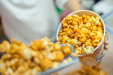 Popcorn in striped bucket on white background