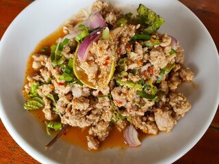 closeup Thai style spicy minced pork salad (Larb Moo) on table