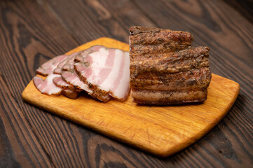 Smoked brisket sliced on a wooden chopping board.