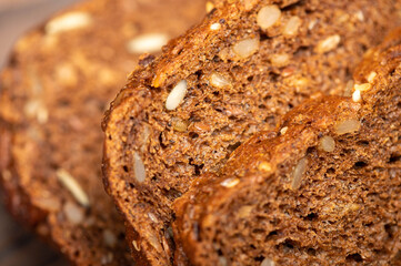 Grain bread sliced on a wooden table.