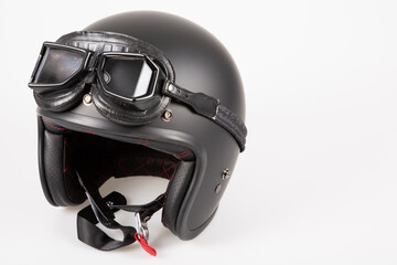 Black motorbike classic helmet with vintage retro google leather isolated on white