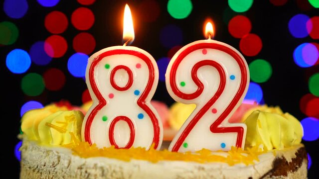 Number 82 Happy Birthday Cake With Burning Candles Topper.