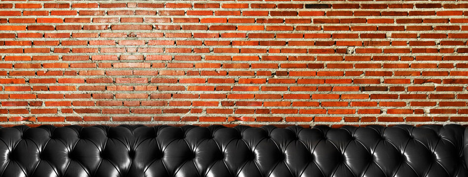 Red Brick Wall And Black Sofa Interior Banner Background