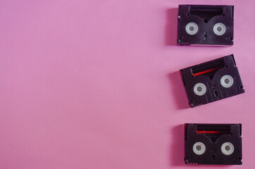 Vintage mini DV cassette tapes on pink background
