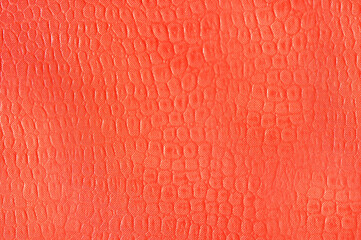 Artificial leather imitation snakeskin orange color.Texture or background