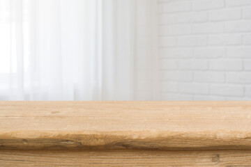 Tabletop on blurred curtained window and white brick wall background