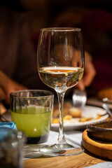 glass with a drink and a glass with lemonade in the foreground, festive dinner.