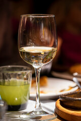 glass with drink on festive dark blurred background, vertical