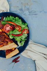 Pieces of cheese pizza and vegetable salad. Lunch idea.