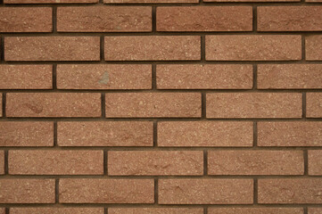 Symmetrical beige brick masonry wall texture