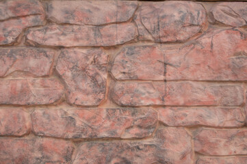 Texture of pale pink wall relief with stone relief