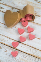 valentines candy heart shapes on white wooden table