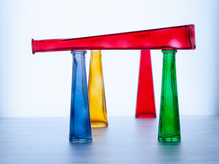 Bottles of bright, pure colors are in a row. Glass.
