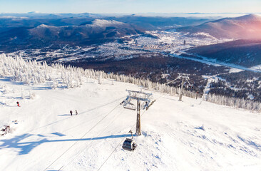 Sheregesh ski lift resort in winter, landscape on mountain and hotels, aerial top view Kemerovo region Russia