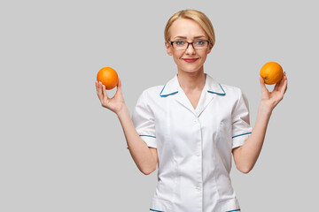 nutritionist doctor healthy lifestyle concept - holding fresh organic orange fruit