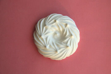 delicious italian dessert white meringues on a pink background