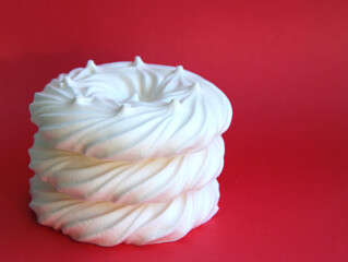 delicious italian dessert white meringues on a pink background