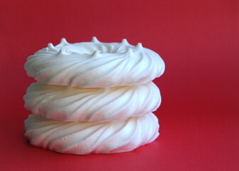 delicious italian dessert white meringues on a pink background